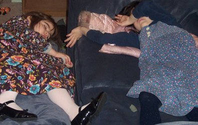 Dassa and Rina, asleep on the ottoman and couch